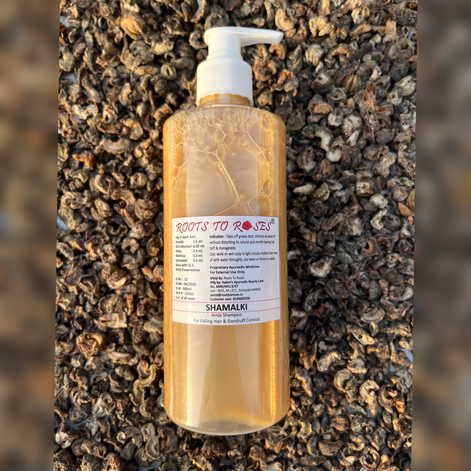 Bottle of 'Roots to Roses Shamakki' on a textured brown background